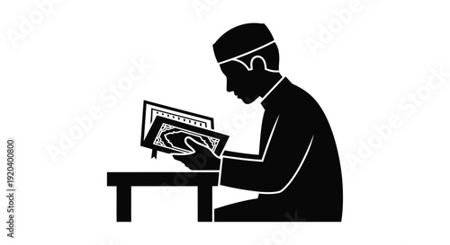 Man studying religious text at a desk a striking silhouette