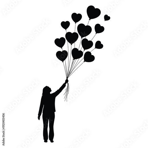 Silhouette of a person releasing heart shaped balloons into the air