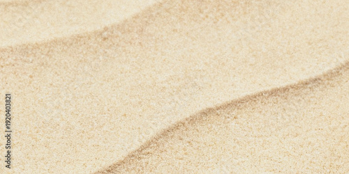 Photos Close up view of light beige sand with subtle wave patterns and granular texture