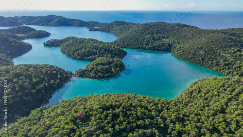 Aerial view of emerald waters embraced by verdant islands, a tranquil paradise unfolds beneath the Croatian sun, Mljet National Park, Pomena, Dubrovnik-Neretva County, Croatia.