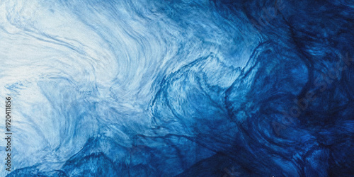 Fotografie Abstract swirling blue ink in water creates a flowing marbled and ethereal visua