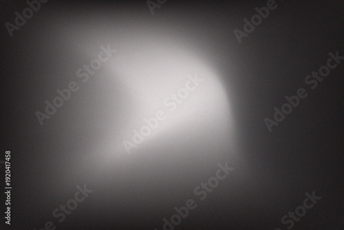 Abstract dark moody background with soft white ethereal light leak and blurred smoky texture