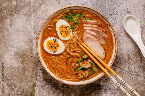 Delicious bowl of ramen with chicken, eggs, mushrooms