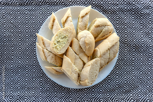 Baguette slices with garlic butter on plate