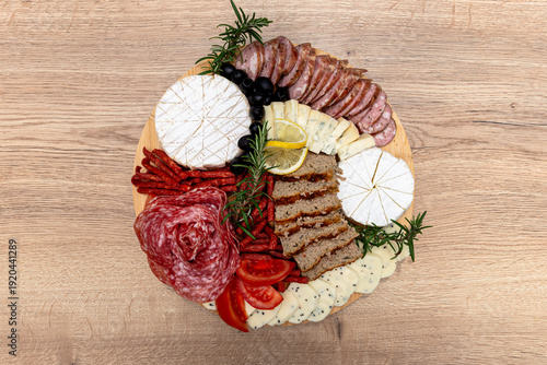 Charcuterie board with assorted cheeses, salami, sausages, and olives