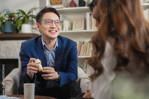 Psychologist conducting couple therapy session with attentive listening and tablet note taking, mental health counseling concept showing relationship analysis, emotional support and professional guida
