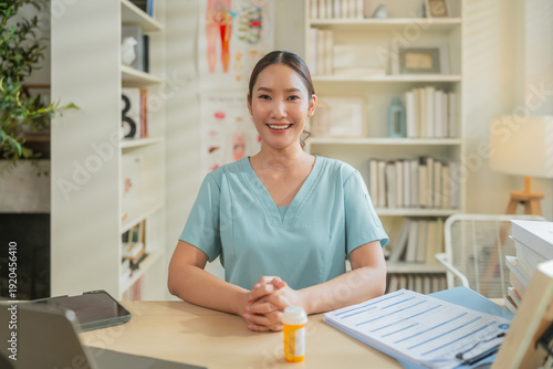 Tablou pe pânză Female healthcare professional reviewing medical documents at desk with laptop in clinic office, administrative medical workflow, patient record management and modern healthcare documentation concept