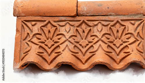Decorative ceramic roof tile with floral pattern and terracotta color  