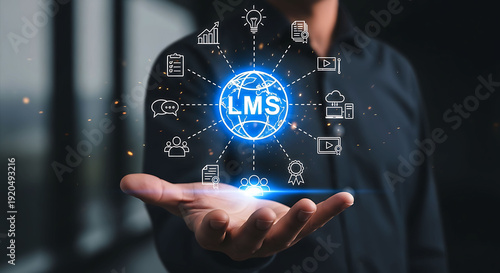 Businessman holding holographic LMS Learning Management System icons