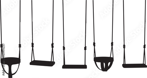 Silhouette of various swings on playground equipment outdoors