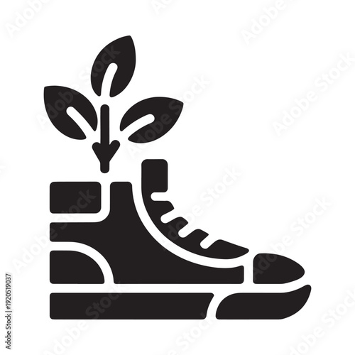 Black silhouette of a boot with a sprouting plant growing from it