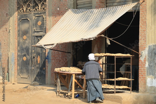 Bakery on a Street of an Egyptian City with Client buying the traditional Eish Baladi 