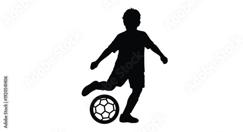 Silhouette of a boy playing soccer with a ball outdoors