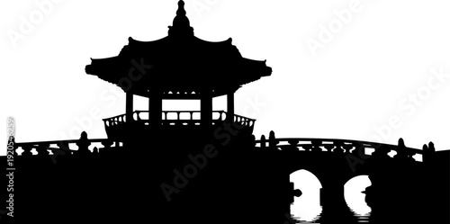 Oriental pavilion and stone bridge silhouette reflecting on water