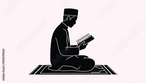 A man sitting on a prayer mat reading a book