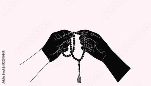 A pair of hands holding a rosary in a praying position