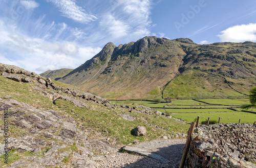 the langdale pikes in great langdale lake district cumbria uk from the footpath above stool end farm sunny spring day no people