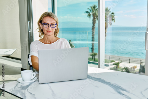 Mature business woman working on laptop computer in office