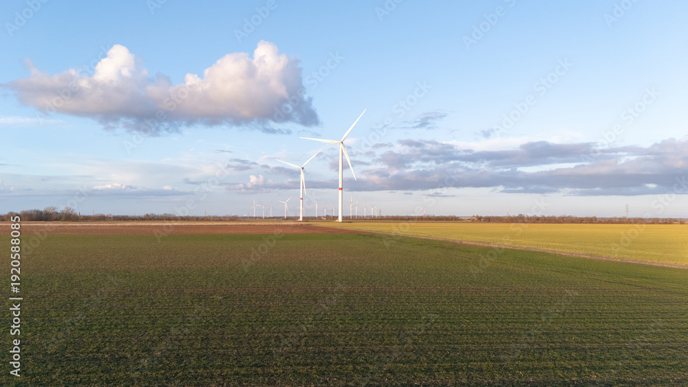 Obraz premium A wind farm with three wind turbines in the distance