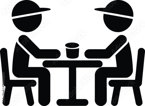 Two people sitting at a table with a cup
