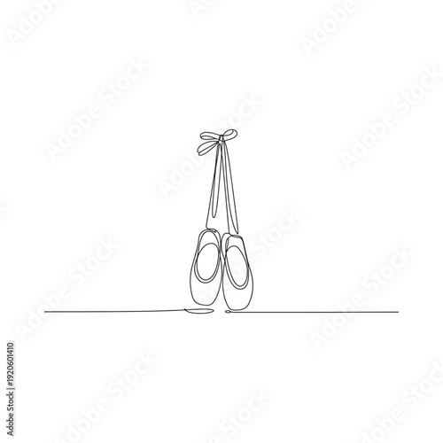 A delicate continuous line drawing showcases a pair of ballet pointe shoes hanging