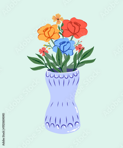 Colorful flowers in a blue vase against a light green background, decorative floral arrangement