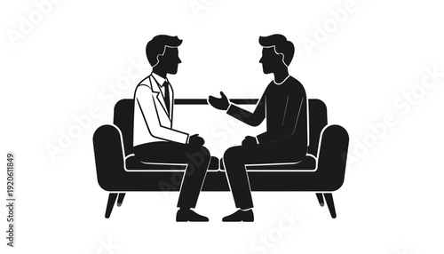 Two men sitting on a couch and talking to each other.