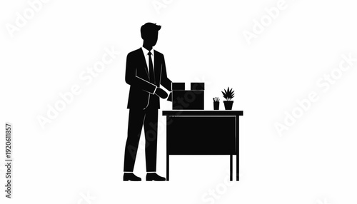 Silhouette of a businessman working at a desk with a computer.