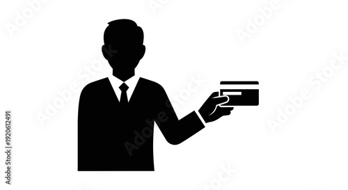 Man in suit holding a credit card in hand.