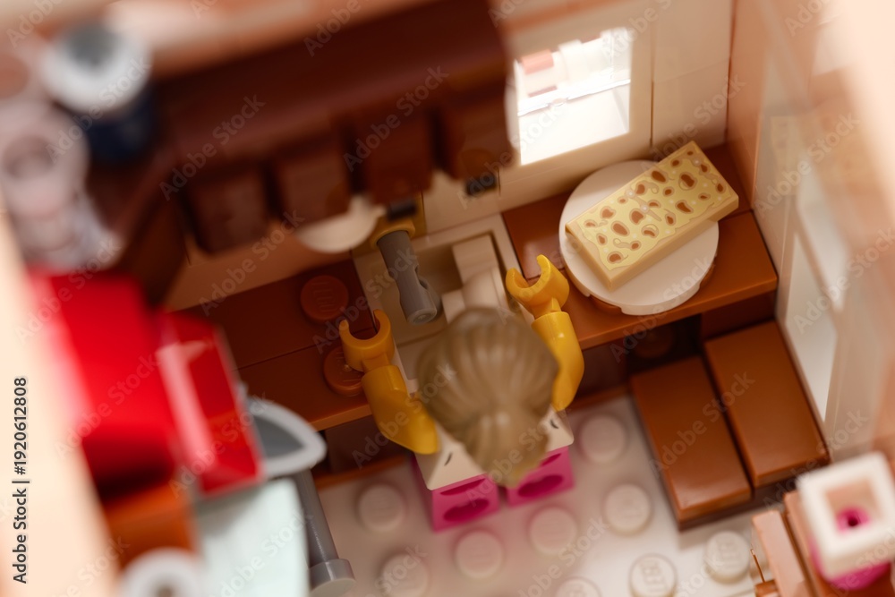 Fototapeta premium Tambov, Russian Federation - February 11, 2026 Lego woman minifigure standing near the sink in her kitchen.