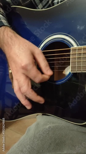 man playing acoustic guitar