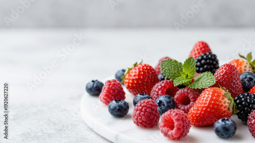 Wallpaper Mural A generous pile of vibrant strawberries and blueberries sits on a white marble surface. Fresh mint leaves add a touch of green. The composition evokes a sense of freshness and indulgence. Torontodigital.ca