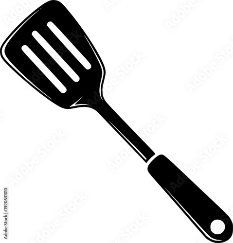 A sleek black spatula with ventilation slots and a hanging hole on a white backdrop