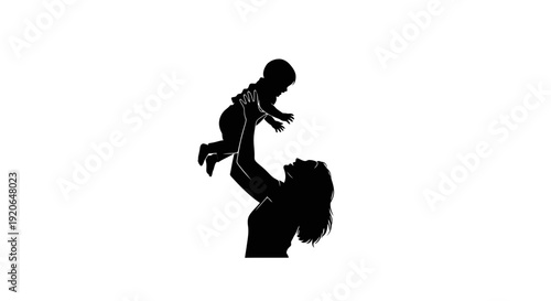 Silhouette of a mother playing with her baby in the air.