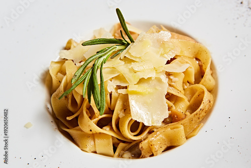 Classic Italian tagliatelle pasta with aromatic fresh rosemary and shaved Parmesan cheese