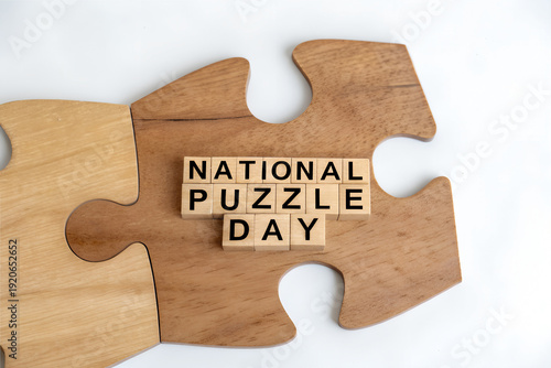 Large wooden jigsaw puzzle piece with aligned Scrabble style tiles spelling National Puzzle Day creating creative visual concept for celebration and awareness event  generative ai