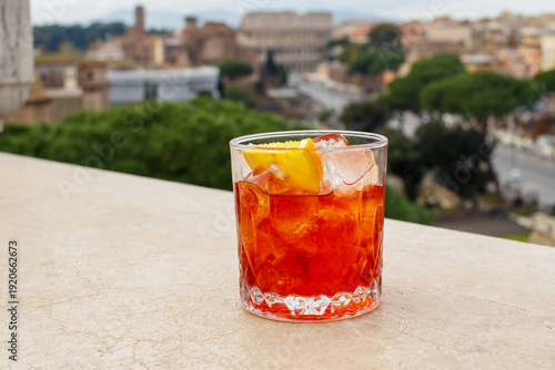 Canvas Print Refreshing orange alcoholic cocktail with ice and orange slice on a terrace with