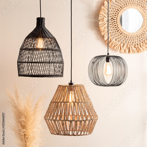 Billede på lærred rattan style lighting fixtures hang on wall near decorative pieces
