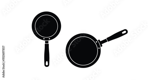 Two black frying pans displayed against a white background silhouette