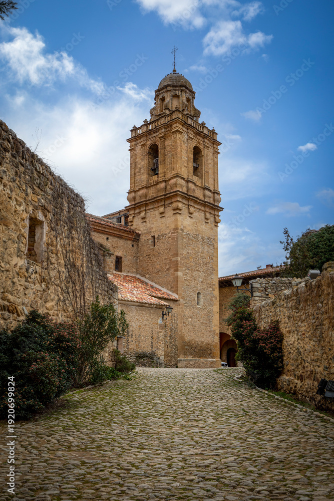Fototapeta premium Vertical photo of the bell tower of the church of Santa Margarita in Mirambel, Teruel, Aragon, Spain
