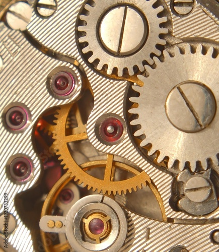 Photography Intricate gears and wheels of an antique pocket watch mechanism.