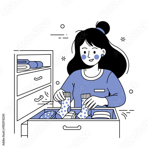 Young asian female organizing socks in drawer with neatly arranged clothes