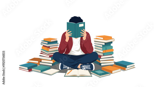 Young student sitting on the floor with a book covering his face while being surrounded by high stacks of textbooks.