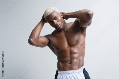 Fit african young male with blonde hair in athletic pose