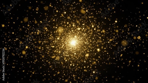 Glittering gold particles explosion on dark background with bright light center and glowing dust