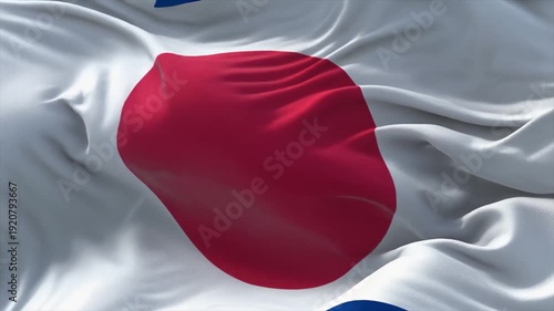 The flag of Japan with a large red disc centered on a white background waving in the wind Japanese flag