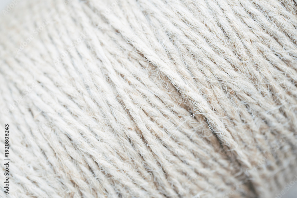 Fototapeta premium Large ball of white fluffy yarn, close-up texture of soft woolen thread for knitting 