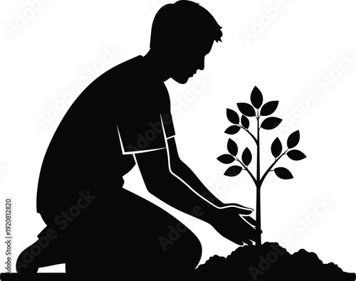 Silhouette of a man planting a sapling