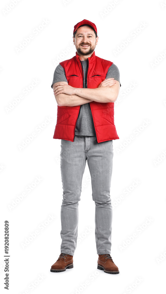 Naklejka premium Smiling long-haul truck driver in uniform with crossed arms on white background