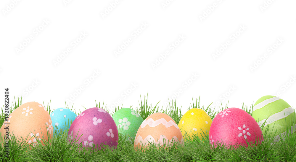 Fototapeta premium Easter eggs in green grass against white background